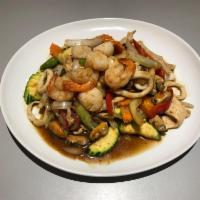 24. Seafood Delight · Sauteed prawns, scallop, squid, green mussels, BBQ pork and chicken with a combination of ve...