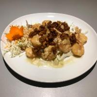 79. Honey Walnut Prawns · Sauteed lightly breaded crispy prawns in special honey sauce and topped with walnuts.