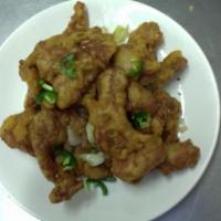 74. Salt and Pepper Pork chops · Deep fried pork chops topped with minced onions and jalapenos.