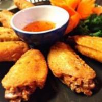 Thai Wings Appetizer · Crispy chicken wings marinated in ginger, garlic and thai spices served with sweet and sour ...