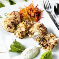 Malai Chicken Tikka Kebab · (GF) Pieces of chicken marinated in a creamy cashew nut, saffron sauce and grilled in the ta...