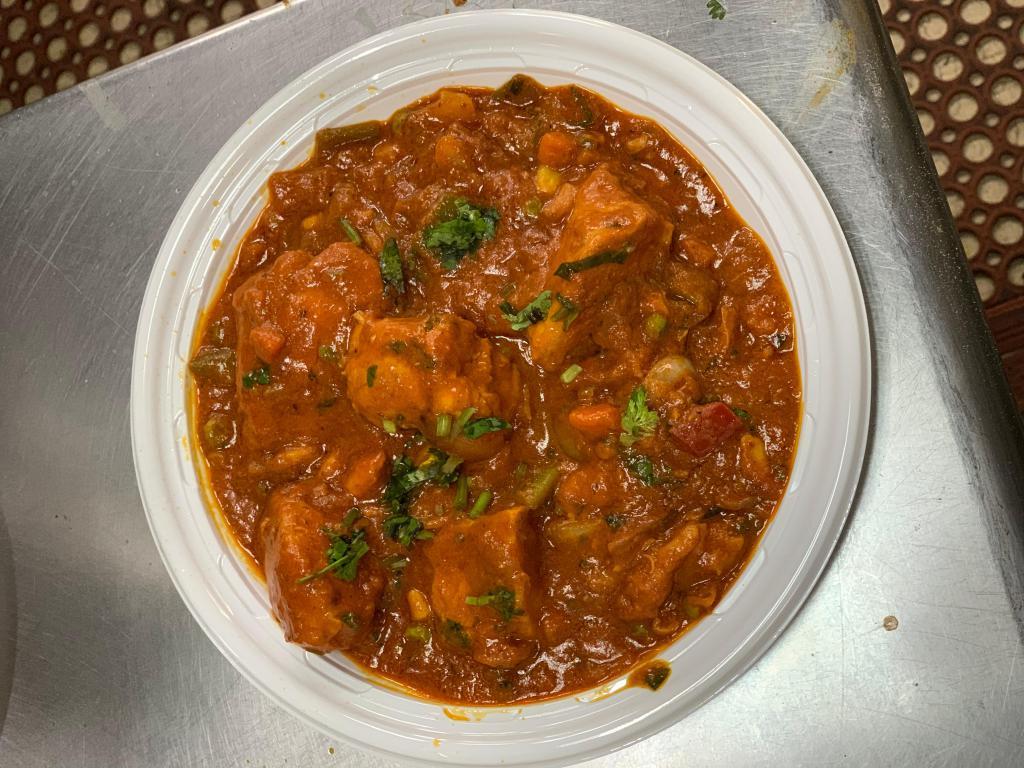 Chicken Curry · Chicken cooked with onions and tomato-based sauce, flavored with ginger, garlic, chilly peppers and a variety of spices.