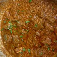 Goat Curry · Goat with bones cooked in onion and tomato-based sauce, flavored with ginger, garlic, chilly...