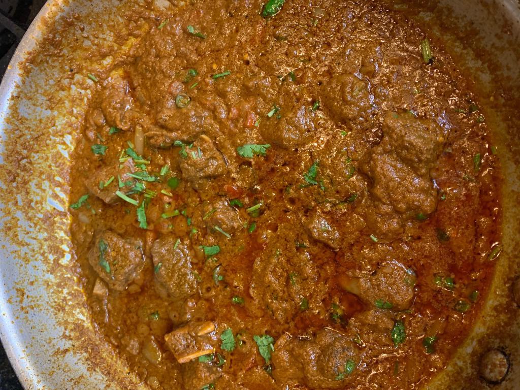 Goat Curry · Goat with bones cooked in onion and tomato-based sauce, flavored with ginger, garlic, chilly peppers and a variety of spices.