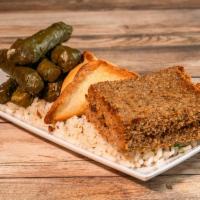 Traditional Combo · 1 fatayer, 1 baked kibbeh and 6 rolled grape leaves. Served with rice and green beans.