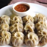 Goat MoMo ( 8 PCS ) · World famous authentic Nepalese dumpling stuffed with ground goat meat served with tomato se...