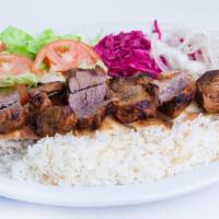 Lamb Kabob Plate · Plate of basmati rice topped with a skewer of lamb kabob and grilled vegetables. Served with...