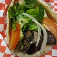 Beef Kabob Sandwich · A skewer of beef kabob, tomatoes, pickles, onions, parsley and tahini sauce wrapped in pita ...