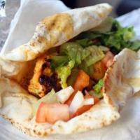 Chicken Kabob Sandwich · A skewer of grilled chicken, tomatoes, pickles, lettuce, and garlic sauce wrapped in pita br...