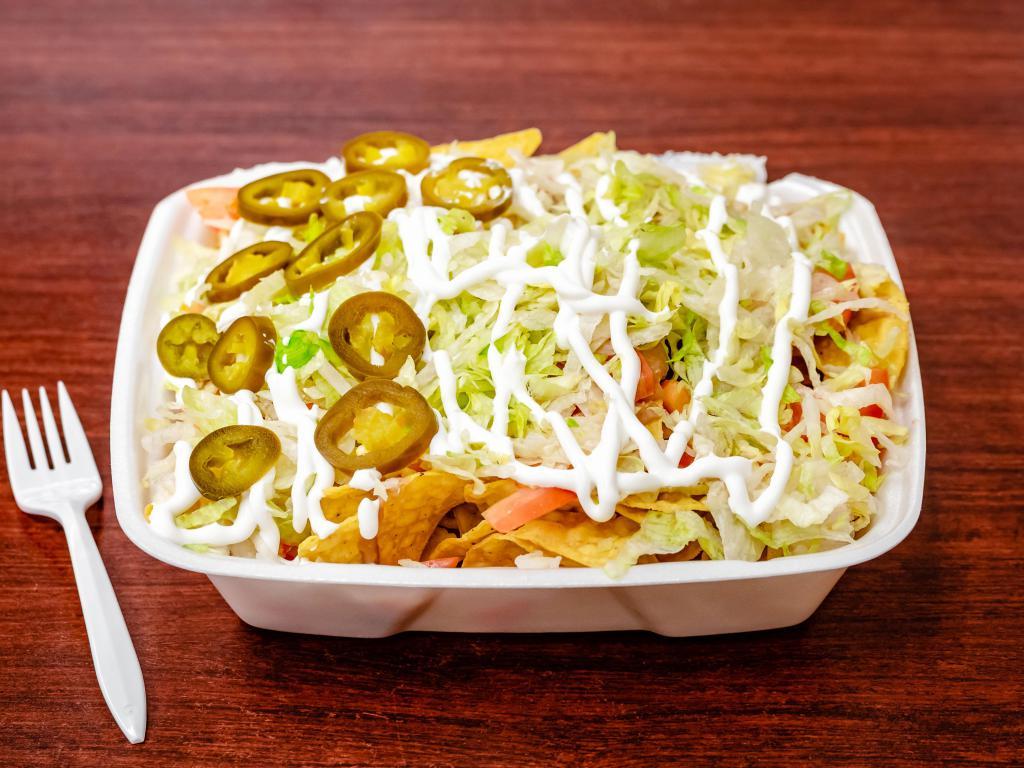 Super Nachos · Includes choice of meat, cheese, beans, lettuce, tomatoes, onions, sour cream, jalapenos and La Bamba salsa.