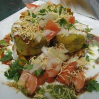 Ragada Chat · Spiced potato patties, topped with chickpeas, mint, tamarind and yogurt sauce.