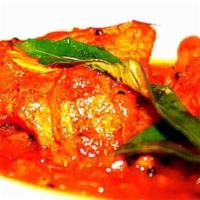 Kerala Fish Curry · Halibut simmered in a tamarind and ginger tangy curry sauce. Served with basmati rice. Hot.