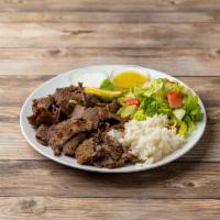 Lamb and Beef Gyro Plate · Lamb and beef cooked on a vertical spit and served with salad and rice.