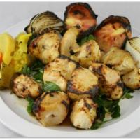 10. Chicken Tikka · 2 skewers chicken breast. Served with grilled tomatoes & onions, pickles, parsley and tandoo...