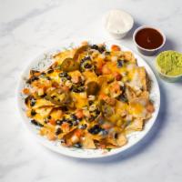 Nachos with Chicken · Freshly made corn chips smothered with black or pinto beans, melted Jack and cheddar cheeses...