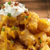 Lots-a-tots · A mountain of tots covered with bacon, cheese, sour cream and green onions. 