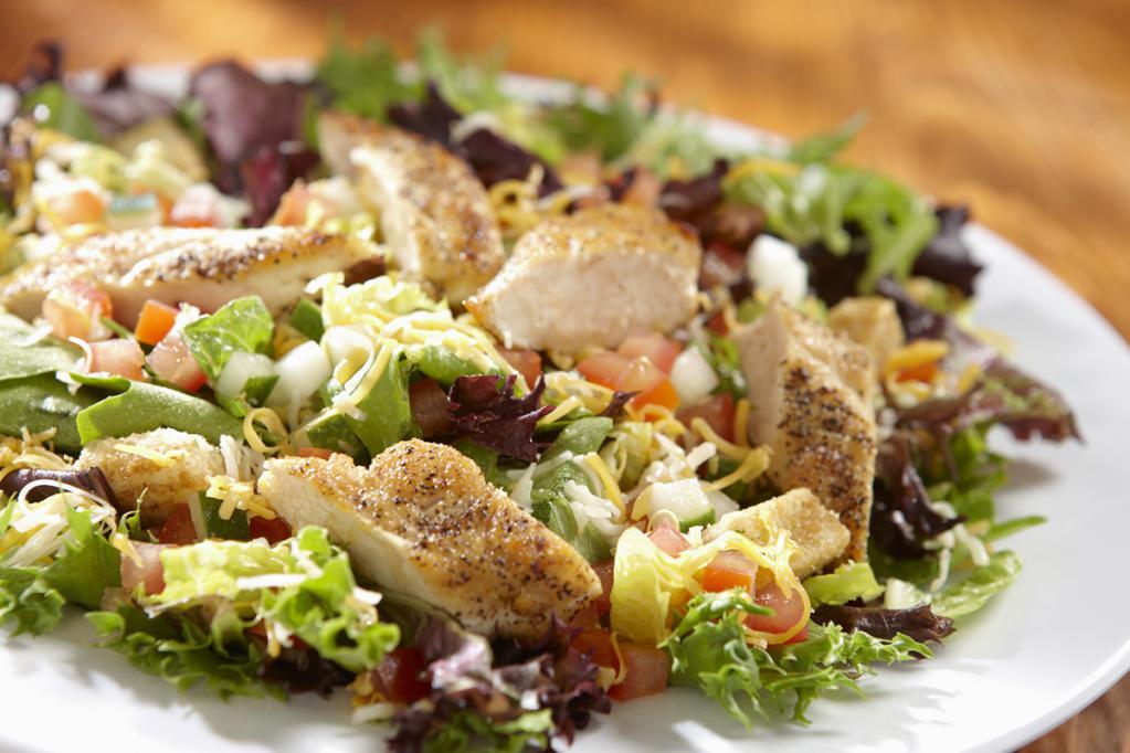 Chicken Garden Salad · Spring mix green piled with diced tomatoes, crisp cucumbers, cheddar cheese and croutons and your choice of salad dressing. Topped with grilled or fried chicken. 
