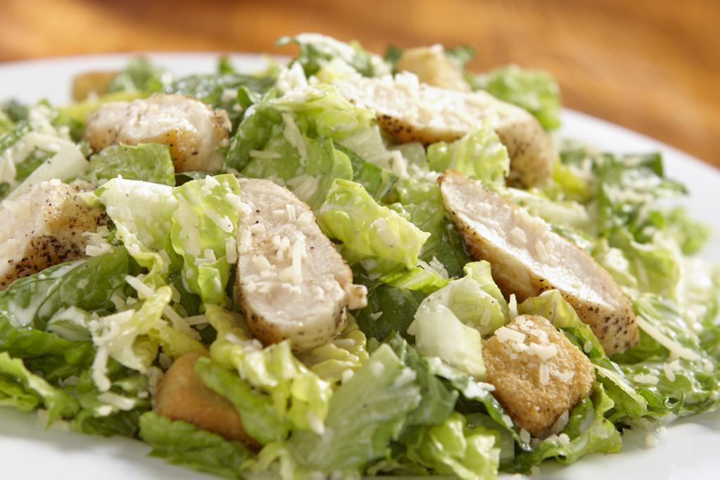 Blackened Chicken Caesar Salad · Fresh chopped romaine, Parmesan cheese and crispy seasoned croutons with a creamy Caesar dressing. Topped with blackened chicken.