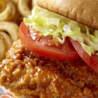 Hooters Original Buffalo Chicken Sandwich · Hand-breaded chicken breast tossed in your favorite wing sauce, topped with lettuce and toma...