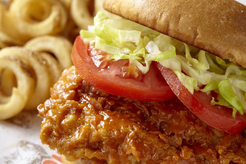 Hooters Original Buffalo Chicken Sandwich · Hand-breaded chicken breast tossed in your favorite wing sauce, topped with lettuce and tomato and served on a toasted brioche bun. 