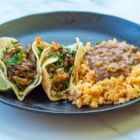 Taco Plate · 2 tacos served with rice and beans.