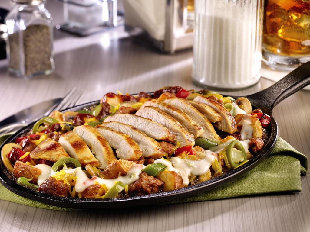 Crazy Spicy Skillet · Chorizo sausage, fire-roasted bell peppers & onions, mushrooms, jalapeños, and seasoned red-skinned potatoes. Topped with grilled seasoned chicken breast, Cheddar cheese, a spicy five pepper sauce, and Pepper Jack queso. Gluten-free.