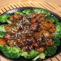 12. Sesame Chicken · Breaded chicken with green and red pepper, onion, surrounded by steamed broccoli in a sweet ...