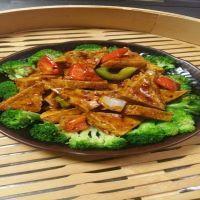 31. General Tso Tofu · Crispy fried tofu with green and red pepper, onion, surrounded by steamed broccoli in a swee...