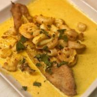 Pescado a Lo Macho · Shrimp, squid and scallops in a spicy, creamy aji Amarillo and garlic shellfish sauce on top...