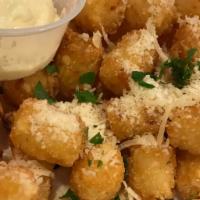 Parmesan Truffle Tots · golden fried tater tots, parmesan cheese, fresh parsley, truffle oil and garlic aioli for di...