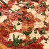 Margherita Pizza · Fresh mozzarella cheese, roasted tomatoes, fresh basil and extra virgin olive oil on an 18