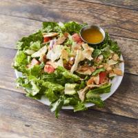 Spinach Fattoosh Salad · A large spinach salad mixed with toasted pita bread. Vegetarian.