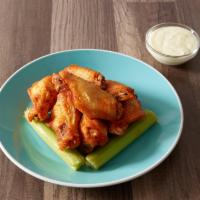 Fire Wings · Tossed in a spicy Buffalo sauce. Served with celery and a choice of blue cheese or ranch.