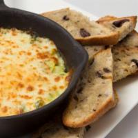 Artichoke Spread · A baked blend of artichoke hearts, freshly shredded Parmesan cheese, and mayonnaise. Served ...