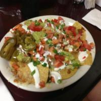 Nachos with Meat · Topped with your choice of jack cheese and yellow melted cheese, beans, guacamole, sour crea...