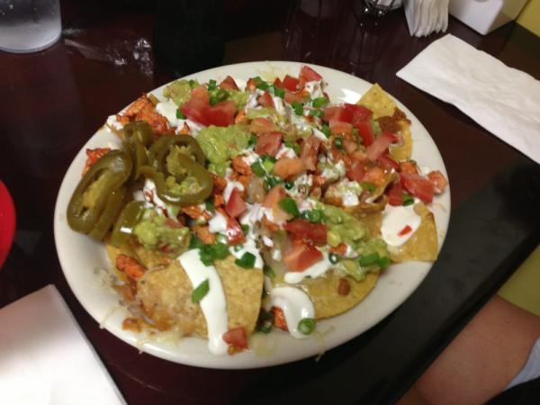 Nachos with Meat · Topped with your choice of jack cheese and yellow melted cheese, beans, guacamole, sour cream, tomatoes, green onions and jalapenos.