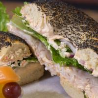Southwest Turkey Sandwich · Turkey, lettuce, red onions, sprouts, and tomatoes with roasted red pepper cream cheese on a...