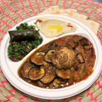 Vegetarian Sampler · Eggplant and zucchini stew, cauliflower dolma, hummus and tabbouleh. Served with pita. Veget...