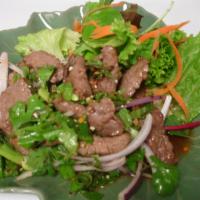 29. Tiger Cry Salad · Beef. Sliced grilled beef mixed with red onion, roasted rice powder and spicy lemon sauce. S...