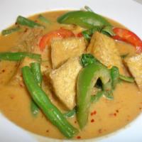 38. Red Curry · Red curry with coconut milk, bamboo shoot, string beans, bell pepper and basil. Served with ...