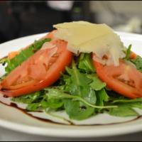Arugula Salad  · Baby arugula, shaved Grana Padano Parmesan, extra virgin olive oil and balsamic vinegar.