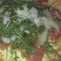 Prosciutto Pizze · White pizza with mozzarella, topped with prosciutto, arugula and shaved Parmesan.