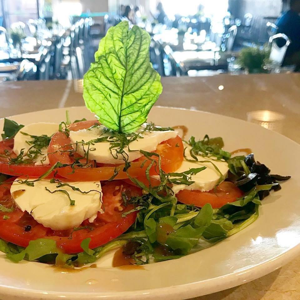 Caprese Salad · Sliced tomato, fresh Mozzarella, fresh basil leaves, prosciutto, arugula and black olives. Served with olive oil and balsamic vinegar.