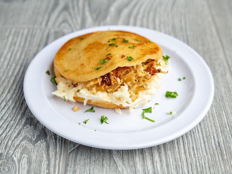 Arepa Perico · Arepa filled with Scrambled eggs with onions, tomatoes, and white cheese.