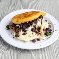 Pabellon Arepa · Yellow plantain, black beans, shredded beef and white cheese.