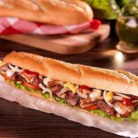 Pepito Steak · Lettuce, onions, tomatoes, potato sticks, mustard, ketchup, and engy sauce on a baguette bre...