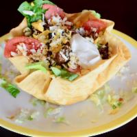 Tostada Salad · A large flour tortilla shell filled with chicken or beef, romaine lettuce, tomatoes, shredde...