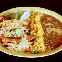 Tacos Los Tios · Beef or chicken. Crispy or soft. Served with Mexican rice, refried beans, lettuce, guacamole...