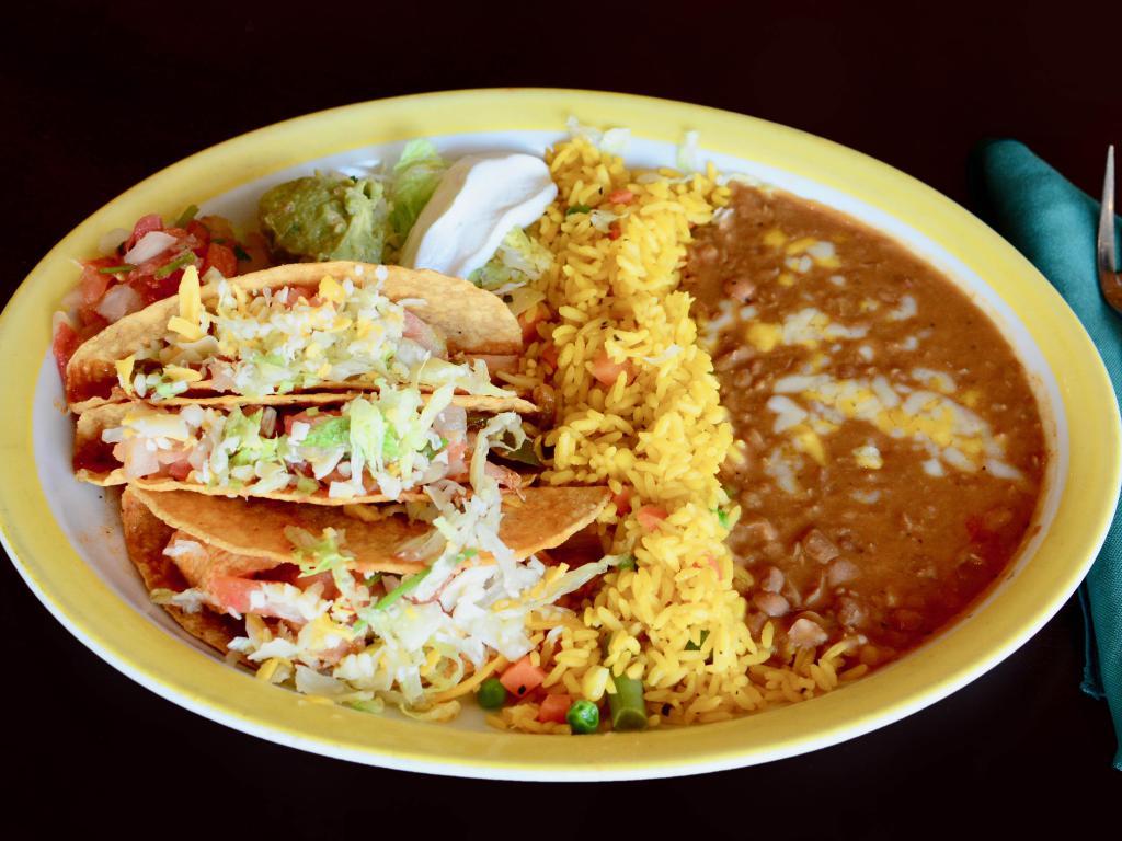Tacos Los Tios · Beef or chicken. Crispy or soft. Served with Mexican rice, refried beans, lettuce, guacamole and sour cream.