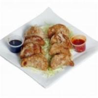 Pot Stickers · Pan fried dumplings filled with chicken and vegetables.